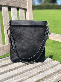 SALE! HALF PRICE!  Was £155, now £78! Crafted from black hair on cowhide on the front and soft, black leather on the back, the Gossan handbag is a stylish, versatile day to evening bag.  Dimensions: Height: 30cm (11.8in) Width at widest part: 26cm (10.2in) Depth at deepest part: 7cm (2.8in) This is a handmade item so measurements may vary from approx. 0.5-1cm. Only one in stock- this one has a few flecks of white cow hair in the black, a natural feature of the piece of cowhide used- see final im Black Leather Shoulder Bag With Leather Lining, Black Leather-lined Crossbody Shoulder Bag, Black Leather Lined Crossbody Shoulder Bag, Everyday Shoulder Bag With Leather Handles And Calf Hair, Black Calf Hair Shoulder Bag For Everyday Use, Everyday Calf Hair Shoulder Bag With Leather Handles, Black Shoulder Bag With Leather Lining For On-the-go, Black Calf Hair Bag With Leather Handles, Black Calf Hair Bags For Everyday Use