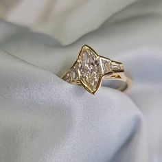 a close up of a ring on a white cloth