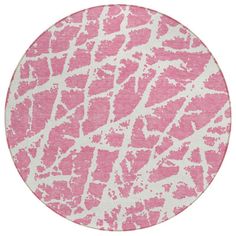 a pink and white circular rug with giraffe print