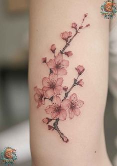 a woman's arm with pink flowers on it