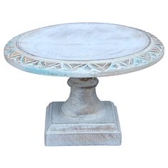 a white pedestal with a glass top sitting on a stand in front of a white background