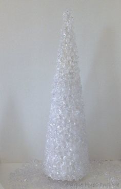 a white plastic christmas tree sitting on top of a table