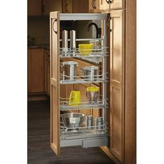 a pull out pantry in a kitchen with wooden cabinets