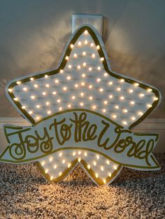 a star shaped sign with lights around it that says,'to the trees '