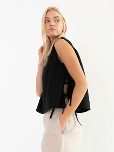 "AVERY is a linen tank top with side ties. DETAILS - Sleeveless design - Crew Neck - Side Ties - Straight cut - 100% lightweight European linen fabric - Cut and sewn to order just for you in our studio COLOR - Black, you can also choose other colors above - Fabric samples are available here https://www.etsy.com/listing/586569696/linen-fabric-samples SIZING & FIT - Fits true to size - Length is approximately 19 inches / 48 cm - Bust is approximately 19 inches / 48 cm - Measurements taken from Linen Sleeveless Top, Linen Wedding Dress, Womens Tank Tops, Linen Crop Top, Linen Tank Top, Linen Tank, Square Neck Top, Tie Top, Black Linen