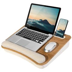 an open laptop computer sitting on top of a wooden desk next to a mouse pad