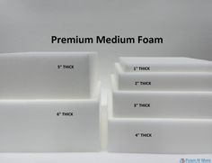 there are four white boxes with numbers on them and the words premium medium foam written in black