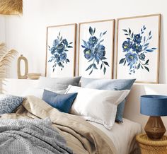 a bed with blue flowers on the wall above it