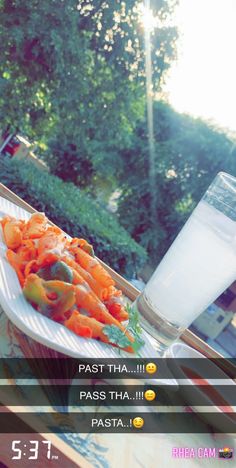 a white plate topped with carrots next to a glass of milk on top of a table