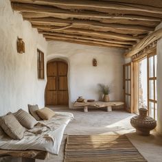 a living room filled with lots of furniture next to an open window covered in wicker