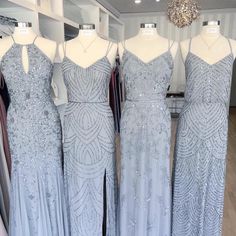 three dresses on mannequins in a store