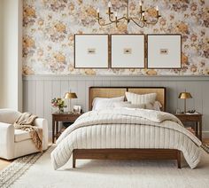 a bedroom with floral wallpaper and white bedding