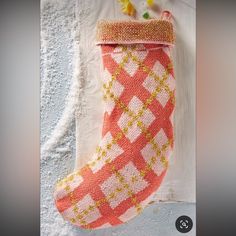 a knitted christmas stocking hanging on a wall