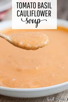 a spoon full of tomato basil cauliflower soup with the title overlay above it