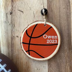 a wooden ornament with a basketball on it that says,'owen 2013 '