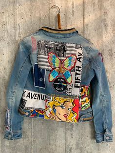 a jean jacket with patches and pictures on it