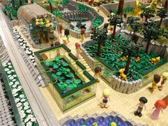 a lego model of a garden with people in it