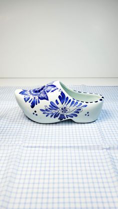 a pair of shoes sitting on top of a blue and white checkered table cloth