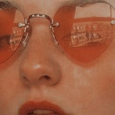 a close up of a person wearing sunglasses with buildings reflected in the glasses on their face