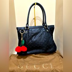 Nice Used Condition Gucci Black Leather Guccissima Medium Sukey Bag. It Does Have Some Discoloration On The Interior From Use As Pictured And Does Have Wear On The Corners From Use Pictured As Well. I Have Included A Brown Gucci Dustbag. It No Longer Has The Interlocking Gg Charm But I Have Included An Unbranded Cherry Bag Charm As Well. I Have Pictured The Serials And The Measurements The Best That I Could. The Handles Are In Great Shape As Well. All Hardware Is Present And Works As It Should . If You Have Any Further Questions Please Feel Free To Reach Out! Thanks! Gucci Black Shoulder Bag With Handles, Cherry Bag, Bags Gucci, Gucci Black, Gucci Bags, Dust Bag, Black Leather, Cherry, Handles