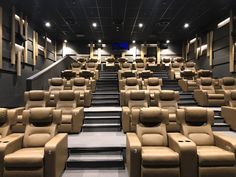 an empty theater with rows of recliners