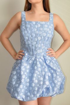 Elevate your style with our Sky Blue Flower Corset Mini Dress. This stunning mini dress is designed to make a statement. Crafted from monochromatic crepe fabric, the corset-style top features a square neckline, fixed tank straps, and eye-catching little flower applied that add a touch of elegance and charm to your look. Below the corset, the mini A-line skirt is gathered at the hem and fastens with an invisible back zipper, ensuring a secure and stylish fit. Made from a blend of 80% Acrylic and Light Blue Fitted Sundress, Fitted Light Blue Sundress, Fitted Mini Dress With Straight Neckline For Spring, Blue Mini Dress With Straight Neckline For Cocktail, Fitted Blue Mini Dress With Square Neck, Blue Fitted Mini Dress With Square Neck, Blue Dress With Straight Neckline For Spring, Blue Spring Dress With Lined Bodice, Spring Blue Dresses With Lined Bodice