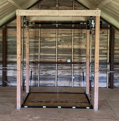 the inside of a building with wooden walls and exposed pipes on the ceiling, in an attic