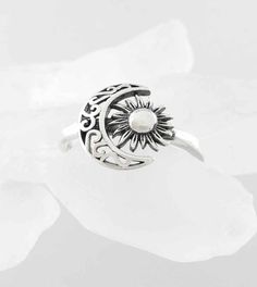 Material: 100% Sterling silver Weight: 2.1 grams Crescent and flower together are 1/2 inch wide x more than 3/8 inch tall (12 x 11mm) Band is more than 1/16 inch wide (2mm) Item number: wh295 The vine-like scrollwork of the crescent moon and the petal-like rays of the sun give this celestial ring an earthy character. The sun is also oxidized for an aged effect and the crescent is cut-out to make the scrollwork more lacey. Crescent Moon And Sun, Finding Feathers, Moon Pentacle, Angel Wing Ring, Angel Ring, Pentagram Pendant, Hummingbird Pendant, Celestial Ring, Rays Of The Sun