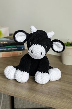 a black and white stuffed animal sitting on top of a table