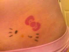 a woman's stomach with a hello kitty tattoo on it