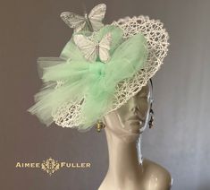 Handmade fascinator with a playful feather-butterflies and gorgeous, sweet mint green tulle! This piece is elegant and beautiful from all angles, and will have all eyes on you on your special day. I can customize this in various colors; please inquire.   Perfect for the bride, baby shower, Easter, or for your next gala/special event.  Also: Del Mar Races, Kentucky Derby, Kentucky Oaks, Easter, Royal Ascot, Mother-of-the-Bride, Weddings, Cosplay, Hat Contests, Church, Derby, Cocktail, High Tea  Some customization available; please message with your requests to see if we can meet your needs. *FREE SHIPPING  For more STATEMENT JEWELRY and HANDMADE HATS go to www.aimeesfuller.com Aimee Fuller has been a trusted online seller since 1999, and is excited to bring her creations back to Etsy.  Thou Whimsical Fitted Fascinator For Spring, Fitted Whimsical Spring Fascinator, Fitted Whimsical Mini Hats For Spring, Whimsical Green Spring Fascinator, Whimsical Fitted Fascinator For Garden Party, Spring Tulle Fascinator, Tulle Fascinator For Royal Ascot, Fitted Tulle Fascinator For Kentucky Derby, Whimsical Fitted Headpieces For Spring