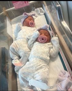 a baby in a hospital bed with an oxygen tube attached to it's head