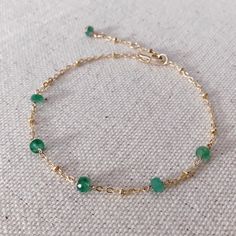 * DETAILS * This dainty natural emerald bracelet is a perfect gift to the one you love or to yourself. A nice every day bracelet. - Genuine Faceted Zambian Emerald Beads - 14K Gold Filled Chain - 14K GOLD FILLED Wire - 14K Gold Filled Bead Cap - 14K Gold Filled Lobster Clasp - 14K Gold Filled Link Rings ✨All components are gold filled. 👉🏻You may also like https://www.etsy.com/JinnysJewelryBySeJin/listing/1074721295/natural-emerald-14k-gold-filled-necklace?utm_source=Copy&utm_medium=Listing Adjustable Dainty Green Chain Bracelet, Dainty Green Beaded Bracelets For Everyday, Dainty Green Adjustable Chain Bracelet, Delicate Green Bracelet As Gift, Green Chain Bracelet For May Birthstone Gift, Dainty Green Bracelets For Everyday, Dainty Green Everyday Bracelets, Dainty Bracelets With May Birthstone For Everyday, Handmade Everyday Bracelets For May Birthstone