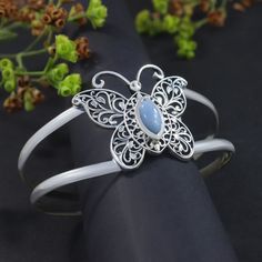 Butterfly Bangle Handmade Blue Opal Gems 925 Sterling Silver Cuff Bracelet Women's Gift Jewelry Type:- Cuff Bangle Product weight:- 24.70gm (approx) Stone:- Blue Opal Stone Size:- 5 x 11mm (approx)  Stone Shape:- Marquise Metal:- 925 Sterling Silver Metal:- IG925     Bangle Diameter:- 62 mm, 2.5 Inch ➤VIEW MORE PRODUCTS------------------------------ ☛RING https://etsy.me/443XLl4 ☛EARRING https://etsy.me/3JhUOUe ☛PENDANTS https://etsy.me/43YCsRQ ☛BRACELETS https://etsy.me/3JjW3Cl ☛NECKLACE https: Bohemian Gemstone Wedding Bangle, Wedding Bangle With Gemstone, Elegant Blue Bangle As Gift, Sterling Silver Cuff Bracelet With Gemstone For Wedding, Adjustable Sterling Silver Bangle For Wedding, Elegant Blue Cuff Bracelet For Gift, Sterling Silver Gemstone Bangle For Wedding, Adjustable Gemstone Bangle For Wedding, Elegant Blue Sterling Silver Cuff Bracelet