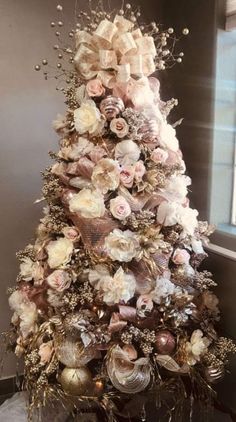 a christmas tree decorated with flowers and ornaments