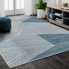 a living room area with a blue rug on the floor