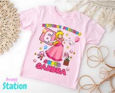 💖WELCOME TO MY STORE💖 Custom t-shirts for all occasions, we can capture all your ideas on t-shirts for birthdays, parties and family trips. ✨ Product details ✨🌬️ Fabric and comfort: Our products are made with breathable, comfortable and somewhat elastic materials. 🌞 Occasion: We have t-shirts for all seasons of the year, short sleeves, 3/4 sleeves and long sleeves, we can customize them for any occasion, be it birthdays, holidays, trips, theme parties and much more, you can send us the desig Pink Graphic Print Shirt For Birthday Gift, Pink Graphic Print Shirt As Birthday Gift, Themed Pink Tops For Birthday, Pink Character Print Shirt For Birthday, Pink Shirt With Character Print For Birthday, Princess Peach Birthday, Peach Birthday, Mario Birthday Party, Mario Birthday