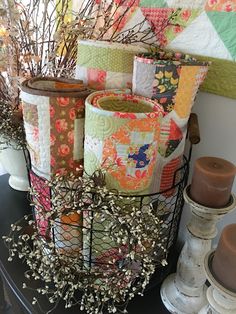 a basket filled with lots of different types of quilts on top of a table