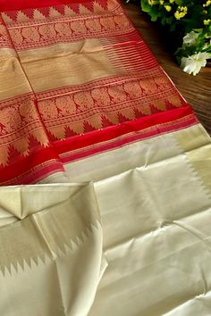 This stunning kanjivaram saree is handwoven in tussar white woven in ettu kol technique. The borders have an ettu kol temple reku woven in gold zari. The grand pallu in vermilion red color features an ettu kol band in gold zari bordering with peacocks and traditional motifs. Approximate Length 6.5 mtrs (inclusive of blouse length) Approximate Height - 48 - 52" Approximate weight - 1.7 lbs Saree comes with fall, picot and tassels done when applicable. Blouse piece is cut. Kindly Note : The colors Vermilion Red, Kanjivaram Saree, Kanjivaram Silk Saree, Kanjivaram Sarees, Traditional Motifs, Blouse Length, Peacocks, Cotton Saree, Blouse Piece