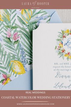 the wedding stationery is displayed with flowers and leaves