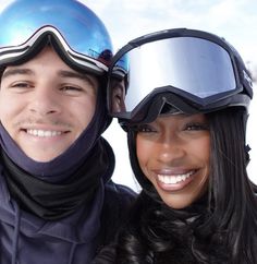 a man and woman posing for a photo with ski gear on