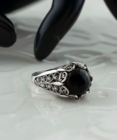 Black Onyx Silver Gothic Cocktail Ring, 925 Sterling Silver Artisan Handmade Medieval Goth Filigree Statement Ring Black stone ring, crown ring, punk ring for women, vintage jewelry Material: 925 Sterling Silver ( NICKEL FREE ) Gemstone: Black Onyx 10 mm. FREE, FAST AND TRACKABLE SHIPPING FOR ALL EU COUNTRIES AND USA. COMES WİTH VELVET POUCH AND LUXURY GİFT BOX. Show off this gorgeous black stone ring at any occasion. This eye catching ring is perfect to add glam to any outfit with Onyx Gemstone. This vintage, original, and stylish luxury jewelry is perfect for wearing at parties, festivals and everyday life.  Our handmade pieces are the perfect gift ring for her, mom, wife, daughter, friend, lover, relative, etc. ideal gift for birthday, anniversary, christmas, graduation, and mothers day Gothic Black Skull Ring, Ornate Black Sterling Silver Rings, Gothic Engraved Rings For Anniversary, Gothic Anniversary Ring With Intricate Design, Black Ring With Intricate Design, Silver Gothic Gemstone Jewelry, Ornate Black Wedding Ring, Elegant Black Sterling Silver Skull Ring, Elegant Black Skull Ring In Sterling Silver