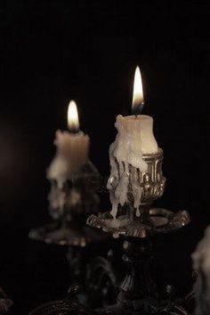 three lit candles sitting on top of a table