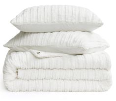 three white pillows stacked on top of each other