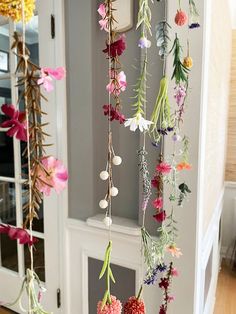 flowers hanging from the ceiling in front of a door