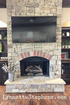 a fireplace with a flat screen tv above it