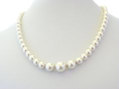 Beautiful beaded Wedding Necklace made of Swarovski Pearls. It is made of one strand of small pearls that get bigger in size at the front and is separated by silver spacers with clear crystals. It's a very romantic necklace that can be used for any bridal gown. The necklace measures approx. 18 inches, but can be made to your desired length (up to 22 inches). It ends with a small silver clasp.See last picture for matching earrings and bracelet available in my shop here: https://www.etsy.com/listi Single Strand Pearl Necklace For Wedding, Pearl Bridal Necklace With Single Strand Of Round Beads, Single Strand Pearl Bridal Necklace With Round Beads, Adjustable Single Strand Pearl Necklace For Wedding, Wedding Pearl Embellished Beaded Necklaces, Single Strand Beaded Necklace For Wedding, White Single Strand Necklace For Wedding, Classic Beaded Pearl Bridal Necklace, Adjustable Classic Pearl Necklace For Wedding