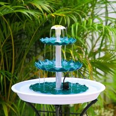 a water fountain with three tiers in the middle