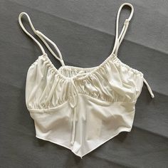 Size Medium. Stretchy Material. Slightly See Through. Ties In Front And Straps Are Adjustable. Urban Outfitters Cami Crop Top, Urban Outfitters Sleeveless Camisole For Summer, Urban Outfitters Sleeveless Summer Camisole, White Strap Casual Crop Top, White Strap Crop Top For Summer, White Strappy Crop Top For Summer, White Strapped Crop Top, Urban Outfitters Cropped Crop Top For Summer, Urban Outfitters Summer Cropped Crop Top