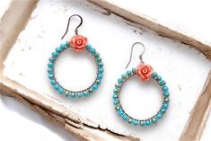 Add a touch of coastal charm to your style with these stunning wire wrapped hoop earrings, featuring blue aqua beads and a gorgeous pink coral flower cabochon. Perfect for bohemian brides, beach weddings, and summer fashion, these earrings embody the carefree spirit of the ocean. With their unique blend of ocean-inspired hues and floral charm, these earrings are sure to turn heads. Whether you're walking down the aisle or strolling along the shore, they're the perfect accessory for any beachy ke Handmade Turquoise Earrings For Spring, Bohemian Jewelry With Ear Wire For Spring, Turquoise Dangle Jewelry For Spring, Bohemian Hoop Earrings As Spring Gift, Bohemian Hoop Earrings For Spring Gift, Bohemian Flower Hoop Earrings With Ear Wire, Summer Gift Wire Wrapped Hoop Earrings, Turquoise Bohemian Earrings For Spring, Bohemian Turquoise Earrings For Spring